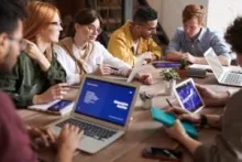 People working on laptops and tablet at a table