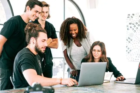 Team viewing a laptop computer